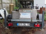 a truck with a trailer attached to it parked in the yard