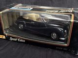 boxed black model of a car in a box on a black surface