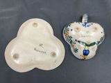 pair of ceramic heart shaped dishes with hand painted designs on them