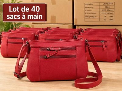 four red purses sitting on top of a table with boxes in the background