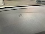 the dashboard of a car with bullet holes on the dashboard