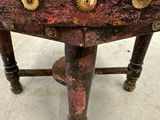 a small table with a glass top and gold gears on it
