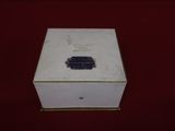 an old white box sitting on top of a red table
