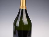 a close up of a bottle of champagne on a white surface