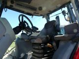 a red tractor with a steering and a steering wheel