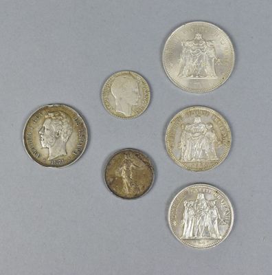 six different types of coins on a table with a white background