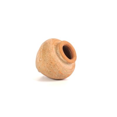a brown vase that is sitting on a white surface