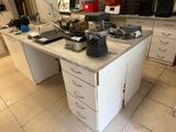 a workbench in the middle of a kitchen with a lot of clutter on top of it