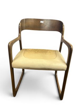 an image of a wooden chair with a beige seat and armrest