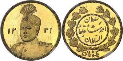 a close up of a gold coin with a picture of a man on it