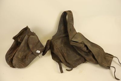 pair of old brown leather bags on a white surface