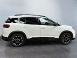 a white suv is parked in a room with a gray floor
