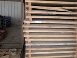 a pile of wood that is stacked up in a warehouse