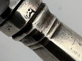 a close up of a silver pen with a black tip