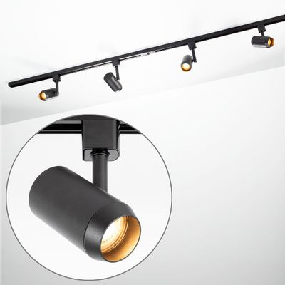 a close up of a black track light on a white wall