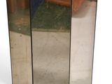 a tall mirror on the floor next to a door