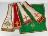 three green and red stoles with crosses and crosses on them