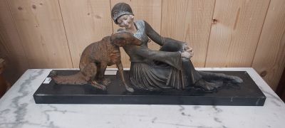 statue représentant une femme assise sur une table avec un chien
