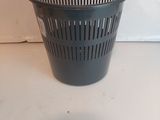 a black trash can sitting on a white counter