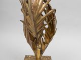 bronze sculpture of a palm tree on a marble base on a white background