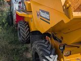 a yellow dump truck that is parked on the side of the road
