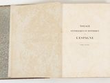 a book opened on a white surface with a black and white cover