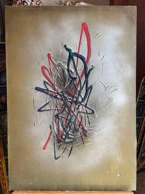 a painting on a easel with a lot of paint on it