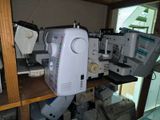 many sewing machines sitting on a shelf in a room