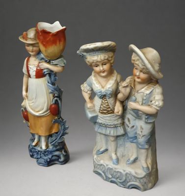 two figurines that are standing next to each other