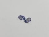 a pair of blue sapphires on a white surface