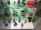 a glass display case with various action figures on it