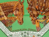 two horses that are standing next to each other on a green background