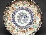 an image of a plate with a dragon on it on a black background