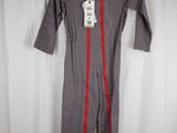 grey and red jumpsuit with red zippers on a hanger on a white curtain