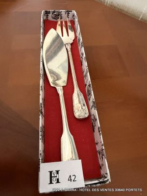 a silverware set in a box on a wooden table