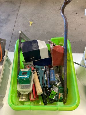 a green container filled with assorted items on a table