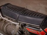 a black and red motorcycle parked in a garage