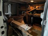 a white van with a wooden beam in the back of it