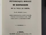 an open book with a black and white image of the title of a poem