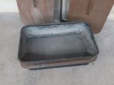 a dirty pan sitting on the floor next to an open door