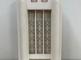 a small white building with a window on top of a table