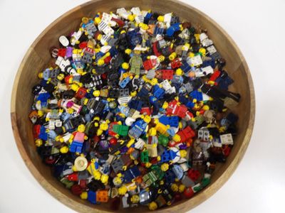 a bowl full of legos sitting on a table