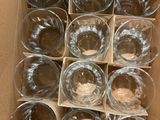 a box of empty wine glasses sitting on the floor