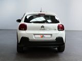 the rear of a white citrole parked in a room