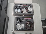 two boxes with tools in them sitting on a table
