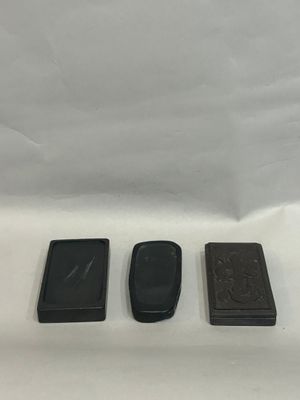 three different types of cell phones sitting on a white surface