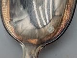 a reflection of a person in a mirror on a spoon