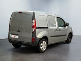 the back of a silver van is parked in a room
