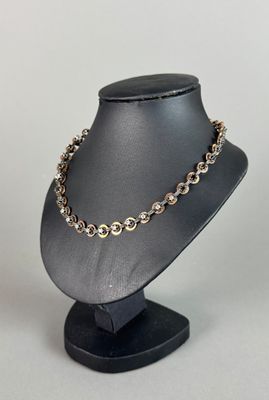 a close up of a necklace on a mannequin stand