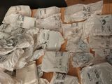 many bags of food sitting on a wooden table